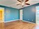 Bedroom with wood floors, ceiling fan, and neutral paint at 1041 Eastbrook Ave, Deltona, FL 32738