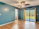 Bedroom with wood floors, ceiling fan, and sliding glass doors to the outside at 1041 Eastbrook Ave, Deltona, FL 32738