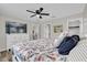 Primary bedroom with a ceiling fan, light-colored walls, and luxury vinyl plank flooring at 1106 Blythe Way, The Villages, FL 32162