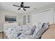 Comfortable bedroom featuring a ceiling fan, dresser, and a cozy bed with stylish patterned linens at 1106 Blythe Way, The Villages, FL 32162