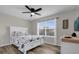 Bedroom with a queen-size bed, ceiling fan, and natural light from a large window at 1106 Blythe Way, The Villages, FL 32162