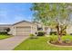 Charming home featuring a well-manicured lawn, attractive landscaping, and a welcoming front entrance at 1106 Blythe Way, The Villages, FL 32162