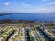 Scenic aerial shot of a waterfront community with canals leading to a large lake under a bright blue sky at 1112 Forest Ln, Tavares, FL 32778