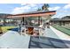 Community outdoor bar area with seating, shade structure, and view of shuffleboard courts at 1112 Forest Ln, Tavares, FL 32778