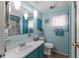 Bathroom featuring a vanity, toilet, shower, and turquoise walls at 1112 Forest Ln, Tavares, FL 32778