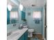 Bathroom featuring a vanity, toilet, shower, and turquoise walls at 1112 Forest Ln, Tavares, FL 32778