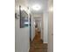 Hallway with hard wood floors, neutral walls, and access to the living spaces at 1112 Forest Ln, Tavares, FL 32778