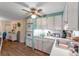 Kitchen with light colored cabinets, wooden floors, and basic appliances at 1112 Forest Ln, Tavares, FL 32778