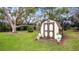 Spacious backyard with a storage shed and mature trees and creative toilet planters at 119 E Croton Way, Howey In The Hills, FL 34737