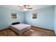 Bright bedroom with blue walls and two windows at 119 E Croton Way, Howey In The Hills, FL 34737