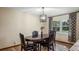 Dining table with black leather chairs, dark wood table and hardwood floors under a pendant light fixture at 119 E Croton Way, Howey In The Hills, FL 34737