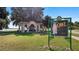 Picturesque park view showcasing the 'White Owl' Citrus Label Tour sign, lush greenery, and a gazebo by the lake at 119 E Croton Way, Howey In The Hills, FL 34737