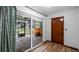 View of the patio with sliding glass doors that overlook a screened-in area with a hot tub at 119 E Croton Way, Howey In The Hills, FL 34737