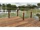 A lovely wooden deck overlooks a serene lake, providing a relaxing outdoor space at 12066 Se 60Th Avenue Rd, Belleview, FL 34420