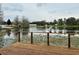 A lake view is seen from a beautiful back deck with wood rails and posts at 12066 Se 60Th Avenue Rd, Belleview, FL 34420