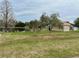 A vast lawn is surrounded by the home's picturesque pond and a barn on the adjacent property at 12066 Se 60Th Avenue Rd, Belleview, FL 34420