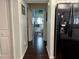 Hallway with a black refrigerator leads to a bathroom featuring a glass door shower at 12066 Se 60Th Avenue Rd, Belleview, FL 34420