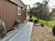 A brown shed with a window and side door; it's surrounded by gravel and has a well-kept lawn at 12066 Se 60Th Avenue Rd, Belleview, FL 34420