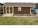 A brown shed with a window and double doors; it's surrounded by a well-kept lawn at 12066 Se 60Th Avenue Rd, Belleview, FL 34420