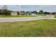 A street view of the neighborhood, with lush lawns, palm trees, and well-maintained houses at 12066 Se 60Th Avenue Rd, Belleview, FL 34420