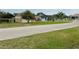 A street view of the neighborhood with multiple homes and lush green lawns at 12066 Se 60Th Avenue Rd, Belleview, FL 34420