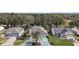 Bird's eye view of a home with a well-manicured lawn, surrounded by trees and neighboring houses in a quiet setting at 1209 Barcelona Dr, The Villages, FL 32159