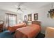 Cozy bedroom featuring twin beds, ceiling fan, and a bright window at 1209 Barcelona Dr, The Villages, FL 32159