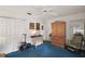 Bright bedroom featuring light walls, blue carpeting, and a ceiling fan at 1209 Barcelona Dr, The Villages, FL 32159