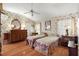 Charming bedroom with floral wallpaper, two twin beds, and hardwood floors at 1209 Barcelona Dr, The Villages, FL 32159