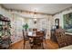 Cozy dining area features hardwood floors, a wooden table and chairs, and large bright windows at 1209 Barcelona Dr, The Villages, FL 32159