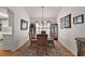 A dining room featuring hardwood floors, an elegant chandelier, and a window with soft lighting at 1209 Barcelona Dr, The Villages, FL 32159