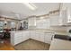 Bright kitchen with white cabinetry, laminate countertops, and a breakfast area at 1209 Barcelona Dr, The Villages, FL 32159