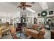 Inviting living room featuring hardwood floors, a skylight, and plush seating arrangements at 1209 Barcelona Dr, The Villages, FL 32159