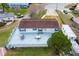 Aerial view of single-Gathering home with large deck and outdoor seating area at 12221 Helena Ct, Leesburg, FL 34788