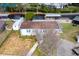 Aerial view of a single-story home with a canal view at 12221 Helena Ct, Leesburg, FL 34788