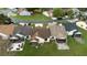 Aerial view of homes featuring backyard patios and green lawns in a lakeside community at 123 Dresdan Ct, Sanford, FL 32771