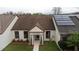 Aerial view of a well-maintained single-story home featuring a manicured lawn and solar panels at 123 Dresdan Ct, Sanford, FL 32771