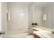 Bright bathroom with white tiled walls and a bathtub with shower at 123 Dresdan Ct, Sanford, FL 32771