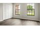 This bedroom features wood-look floors, large windows, and a closet with louvered doors at 123 Dresdan Ct, Sanford, FL 32771