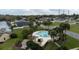 Aerial view of a community pool area surrounded by palm trees and green space with neighborhood homes in background at 123 Dresdan Ct, Sanford, FL 32771