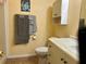 Bathroom with a toilet, sink, cabinet, and towel rack at 1234 E Schwartz Blvd, Lady Lake, FL 32159