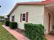 Charming home displaying house numbers, complemented by red trim and lush landscaping at 1234 E Schwartz Blvd, Lady Lake, FL 32159