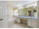 Bright bathroom featuring a double sink vanity, soaking tub, and large mirror at 13219 Meadowlark Ln, Orlando, FL 32828