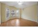 Bedroom featuring three windows, laminate flooring, and a ceiling fan at 13219 Meadowlark Ln, Orlando, FL 32828