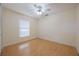 Bright bedroom featuring laminate flooring, a ceiling fan, and a window at 13219 Meadowlark Ln, Orlando, FL 32828