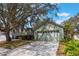 Charming single-story home featuring a two-car garage, manicured landscaping, and a welcoming entrance at 13219 Meadowlark Ln, Orlando, FL 32828