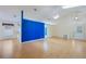 Bright living room with vaulted ceilings, skylights, light wood floors, and a bold blue accent wall at 13219 Meadowlark Ln, Orlando, FL 32828