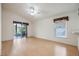 Bright living room with wood floors, sliding glass doors leading to screened lanai and backyard at 13219 Meadowlark Ln, Orlando, FL 32828