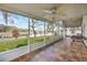 Screened-in porch with tile flooring and a view of the lake at 13219 Meadowlark Ln, Orlando, FL 32828