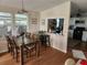 Inviting dining room featuring a wooden table, four chairs, and ample natural light at 1336 E Schwartz Blvd, Lady Lake, FL 32159